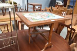 A vintage oak framed firescreen/table having tapestry panel