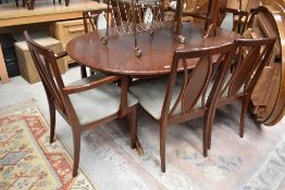 A reproduction Regency dining table and set of six (four plus two) dining chairs having green dralon