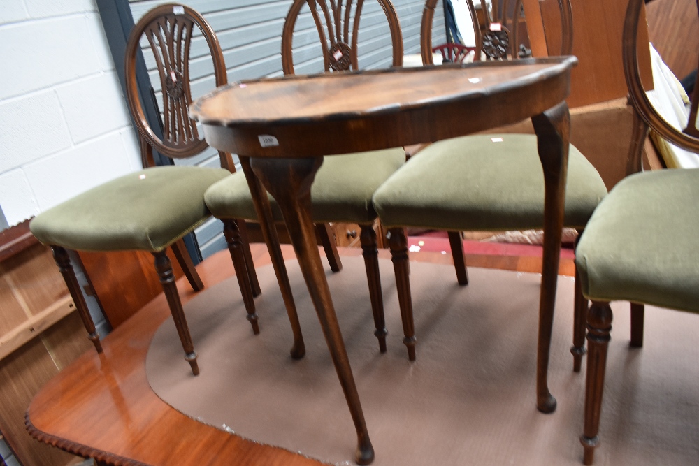 A 1930s walnut demi lune hall table