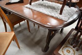 A late C20th oak effect dining table on refectory style base, approx 170cm, and a set of four