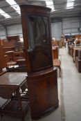 A reproduction Regency mahogany corner display cabinet