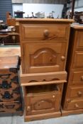 A pair of modern pine bedside cabinets (one without drawer)