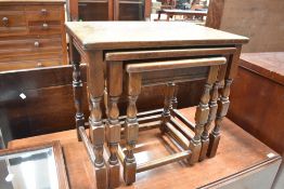 A traditional nest of three oak tables