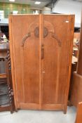 An Edwardian wardrobe with oak carcass and decorative front panel 91cm wide