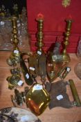 A selection of hardware including model canon, brass iron and candle sticks
