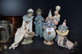 Four clown figure studies three by Lladro and one by Nao