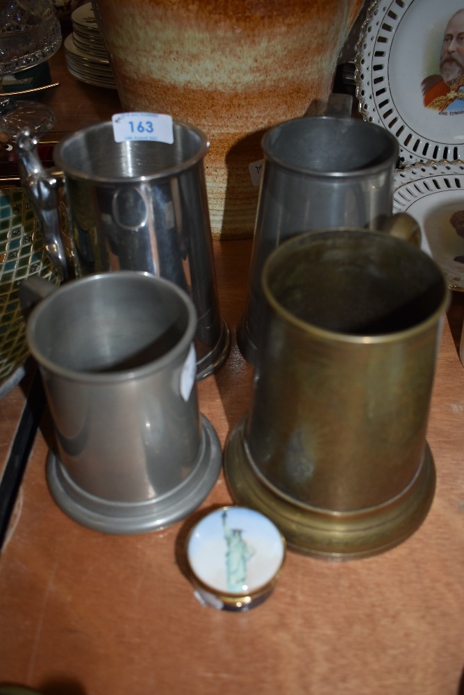 A selection of pewter mugs and tankards.