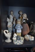 Four figure studies by Lladro and five by Nao including animal and still life figures