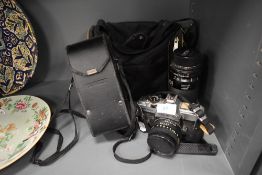 A Fujica STX-1n camera with 50mm lens and a Tamron 80-210mm zoom lens in a soft camera bag