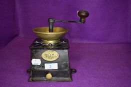 An antique kitchen coffee grinder having worn name plate but stamped no. 9