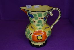 A hand painted art deco style water jug marked Wade to base