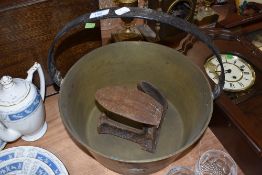 A large brass jam pan and a cobblers last.
