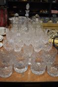 A large collection of cut glass and similar including wine glasses,tumblers and decanters.