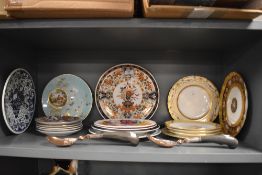 A selection of ceramic plates including Chinese style and hand decorated with cottage scene