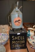 Two garage petrol cans for Shell motor spirit and Pratts also an Aladdin pink paraffin tank