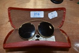 A set of vintage clip on polarised lenses with original tags attached.