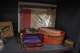 A selection of vintage advertising containers including Mackintosh Carnival biscuit tin