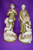 A pair of shepherd figures by Royal Dux with goat and sheep on naturalistic bases one having