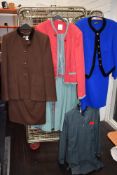 A mixed lot of ladies retro clothing including skirt sets and jackets.