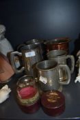 Four pewter tankards or mugs and a similar copper and pewter lined copper creamer