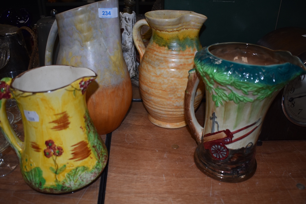 Four vintage water jugs including two art deco design by Beswick, Price bros and Burleigh ware
