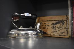 A vintage utility De Luxe Electric iron in original box