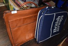 A vintage 1980's British Airways carry bag and a similar tan leather satchel