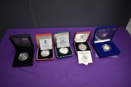 A collection of five UK Silver Proof Five Pound Coins in cases with certificates, 2000 Millennium,