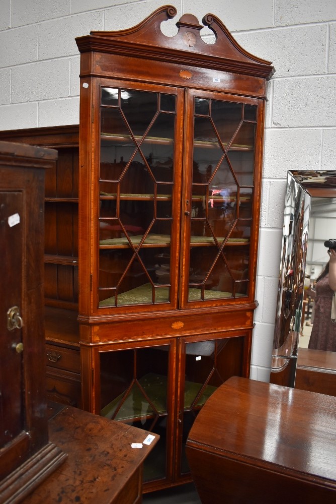 An Edwardian Sheraton revivial corner display having typical inlay decoration, broken scroll