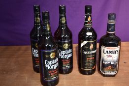 A bottle of Lamb's Navy Rum 1 litre 43% vol and four bottles of Captain Morgan Rum and Jamaica Rum