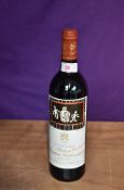 A bottle of Chateau Mouton Rothschild 1994 Pauillac, Classe Premier Cru 12.5% vol 75cl, with paper