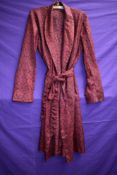 A gents 1960s Tootal dressing gown in red.