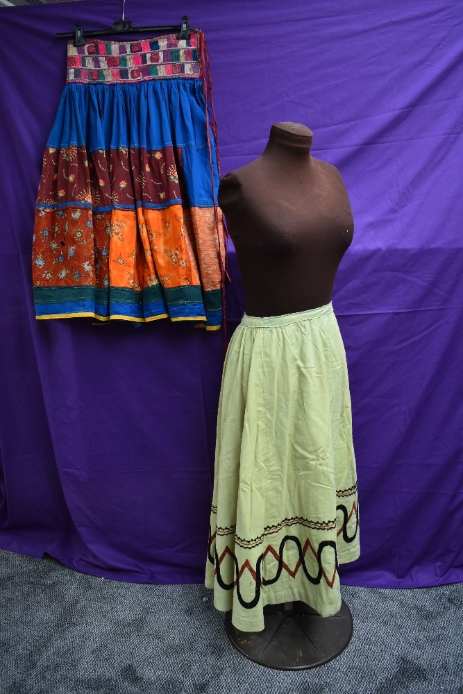 An early 20th century lime green skirt with embroidered detailing and bright vintage ethnic skirt.