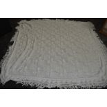 An antique white knitted bed spread,approx 98' X 76',good condition.