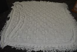 An antique white knitted bed spread,approx 98' X 76',good condition.