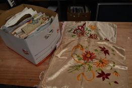 A collection of vintage and antique table linen, embroidered cushion covers and more.