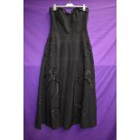 A 1950s black strapless dress with sequin detailing,back metal zipper and 'lady in black' label, a