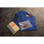 A 1960s girl guides blouse with a collection of badges, book and spare badge.