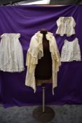 An antique wool christening shawl or similar,a tulle babies gown and more.