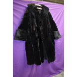 A striking vintage black fur coat having wide sleeve openings with turn up and shawl collar,serviced