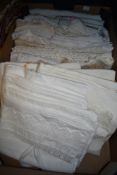 A box of antique and vintage table linen and bedding, some embroidered and others with crotchet