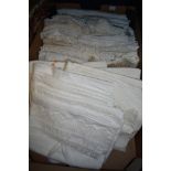 A box of antique and vintage table linen and bedding, some embroidered and others with crotchet