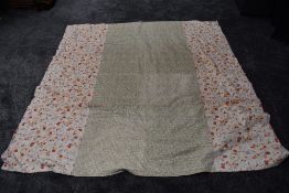 A large vintage quilt having floral section used throughout and backed in white cotton.
