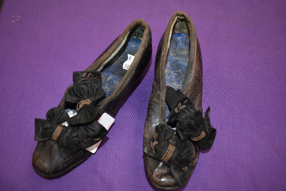 A pair of Victorian Childrens shoes with bow and beading detail to fronts.