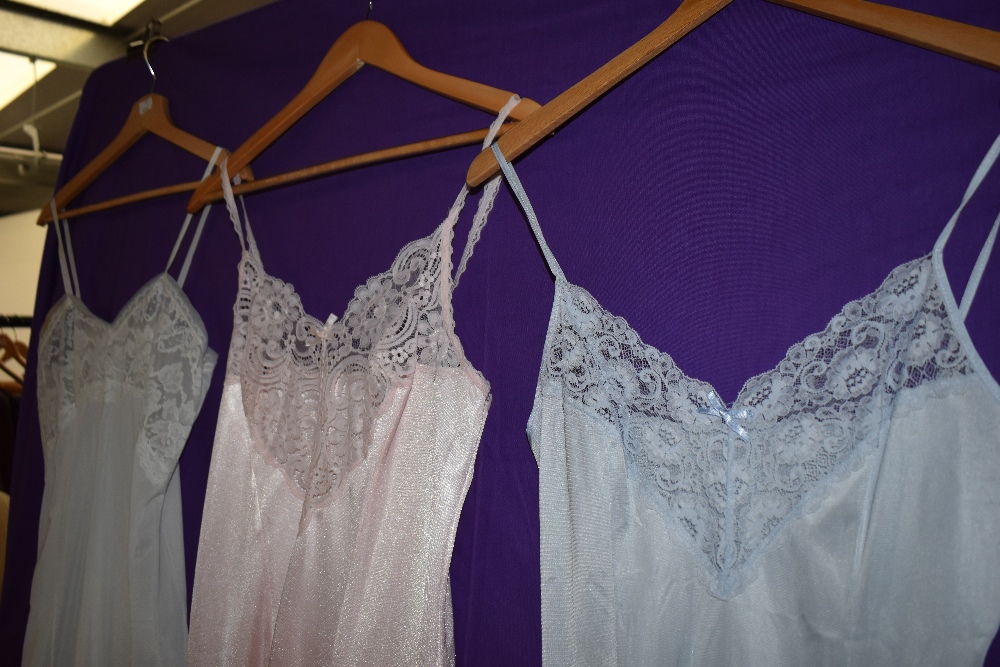 A collection of vintage nylon slips in a variety of colours, one having matching knickers. - Image 3 of 3