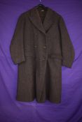 A gents 1940s double breasted overcoat in brown herringbone wool.