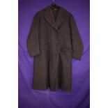 A gents 1940s double breasted overcoat in brown herringbone wool.