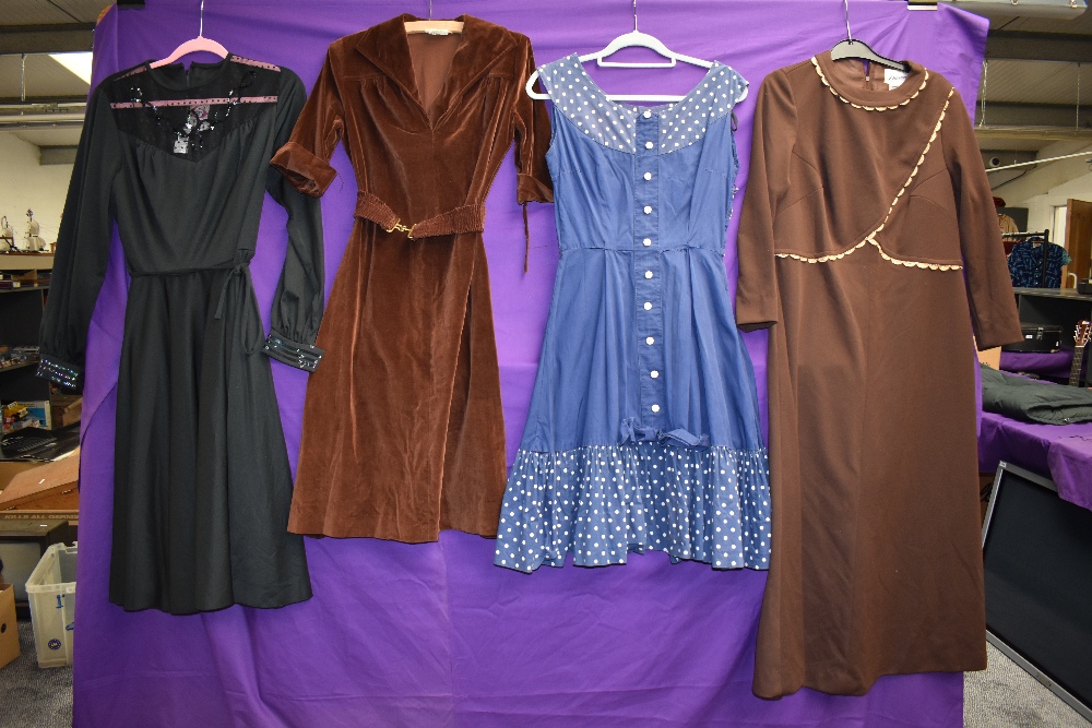 Four vintage dresses including blue 1950s with polka dot accents and 1970s brown velvet with belt.