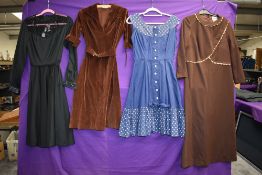 Four vintage dresses including blue 1950s with polka dot accents and 1970s brown velvet with belt.