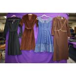 Four vintage dresses including blue 1950s with polka dot accents and 1970s brown velvet with belt.